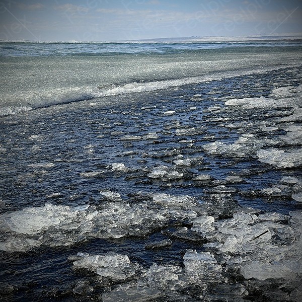 Schritte auf Eissplittern am Black Sand Beach